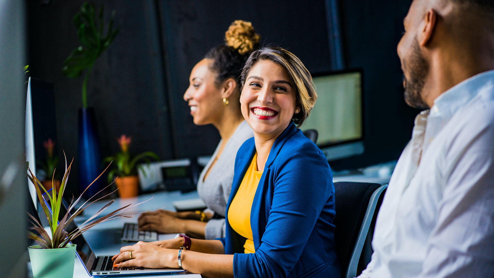 business woman turning and smiling to a business man